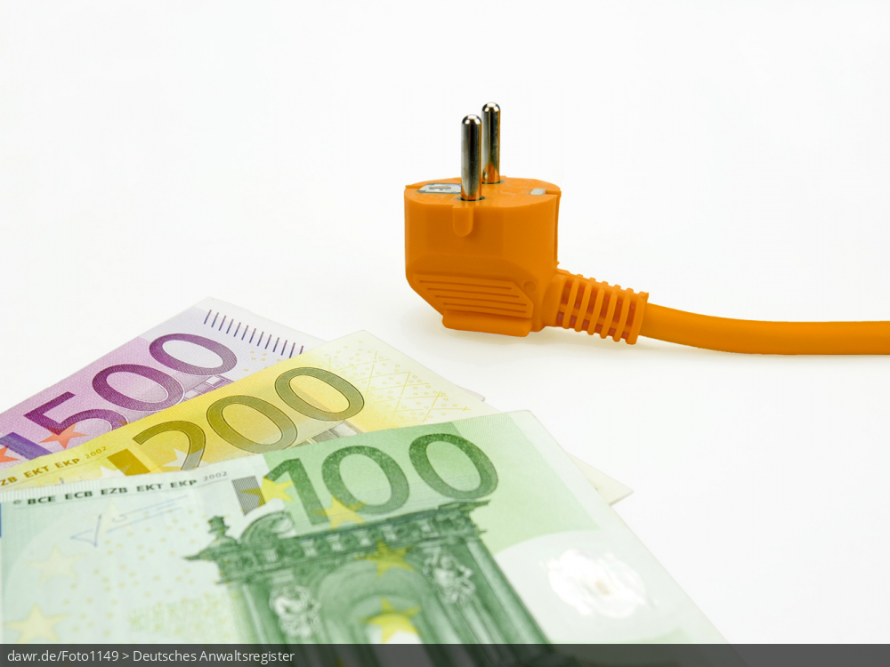 Dieses Foto zeigt mehrere Geldscheine, die auf einer weißen Fläche liegen. Auf den Banknoten liegt ein oranger Stromstecker. Dieses Bild eignet sich gut als symbolische Darstellung für alle Themen in Zusammenhang mit Stromkosten.