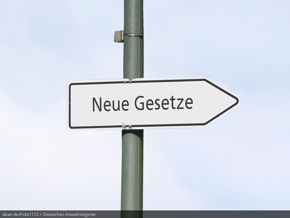 Dieses Foto zeigt einen Wegweiser, wie man ihn in verschieden Formen auf deutschen Straßen findet. Das Verkehrsschild trägt die Aufschrift „neue Gesetze“.